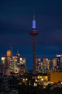 The top of the Europe Tower in Frankfurt am Main shines in the blue of the European Union (EU)