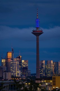 The top of the Europe Tower in Frankfurt am Main shines in the blue of the European Union (EU)
