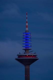The top of the Europe Tower in Frankfurt am Main shines in the blue of the European Union (EU)