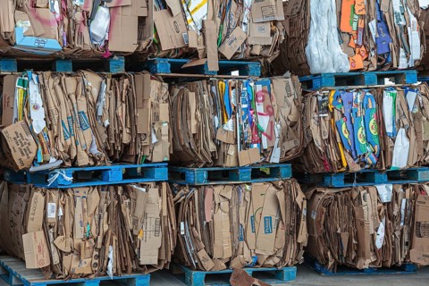 Crushed cardboard boxes bundled on pallets for recycling