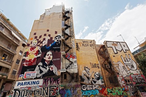 Graffiti-painted house walls, portraits of three Turkish activists who died on hunger strike,