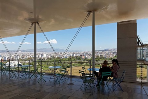 Couple on the panoramic terrace, view of the landscape park and Athens, Cultural Centre of the