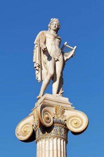 Column with statue of Apollo in front of the Academy of Athens, blue sky, sculptor Leonidas Drosis,