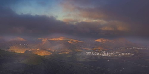 Panorama at sunrise from Montana de Guardilama to the wine-growing region of La Geria, with the