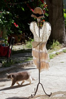 Clothes rack with summer dress in the morning light, placed in front of a fashion boutique, Plaka