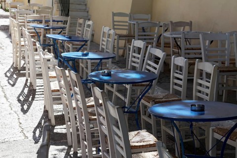 Row of blue tables and white chairs, taverna in the historic centre of Plaka, Athens, Greece,