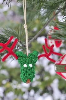 Funny green and red handmade reindeer Christmas ornament with pipe cleaner antlers and other red