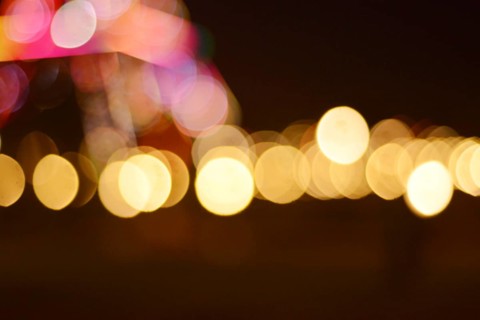 An abstract image featuring blurred lights in circular bokeh patterns with a warm and dreamy