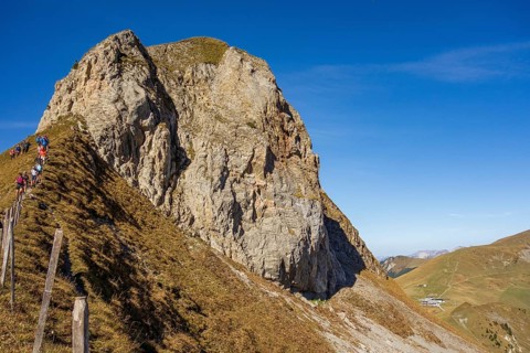 Steep cliff with hikers along a path under a clear sky, saas Fee, Alps, Switzerland, Europe