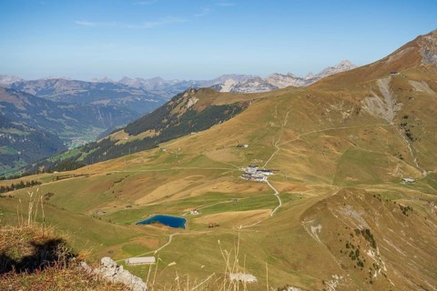 View of a wide valley with a small lake in the middle of a mountainous landscape, saas Fee, Alps,