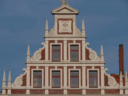 Decorative gable of a building with white decorations and windows, lüneburg, germany