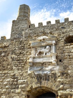 View of seaward outer wall with tower and battlements seen from harbour entrance of fortress built