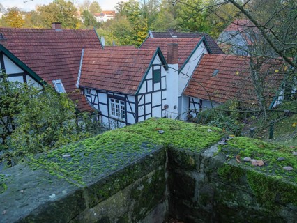 Village view with half-timbered houses, red roofs and moss-covered stones in autumn, Tecklenburg,