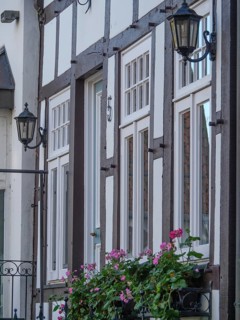 Half-timbered houses with flower boxes and lanterns on the facades, a cosy atmosphere, Tecklenburg,