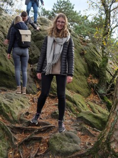 A woman enjoying autumn hiking over rocky terrain with friends, Tecklenburg, North