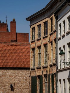 Rows of brick houses and plastered facades under a clear sky, de haan, Belgium, Europe