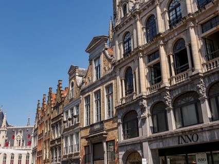 Row of historic buildings with detailed facades and windows in the city centre in clear summer