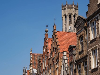 Historic cityscape with striking towers and brick buildings on a sunny day, Bruges, Belgium, Europe