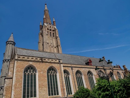 Large Gothic church with towers and large windows in Bruges on a sunny day, Bruges, Belgium, Europe