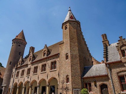 A medieval castle with high towers and an archway, Bruges, Belgium, Europe
