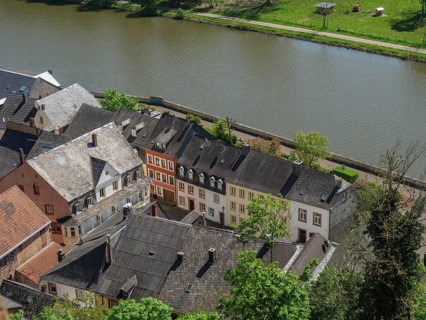 View of a historic old town from above with a river and green landscape in the background,