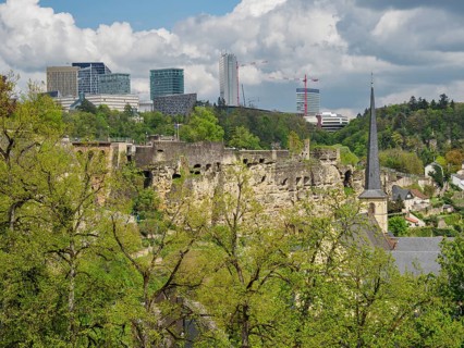 Ruins of a castle in front of a modern skyline with skyscrapers and green spaces, Luxembourg City,
