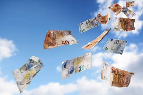 Flying money coming down from the blue sky, twenty and fifty paper banknotes in euro currency,
