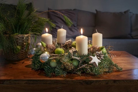 Second Advent, wreath with two burning white candles and Christmas decoration on a wooden table in