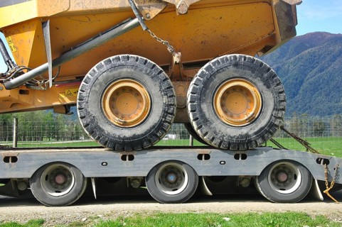 Detail of the wheels of a 30 ton dump truck loaded on a semi-trailer