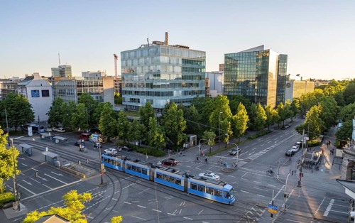 View from above of the crossroads at Stiglmaierplatz with tram, modern office buildings in the