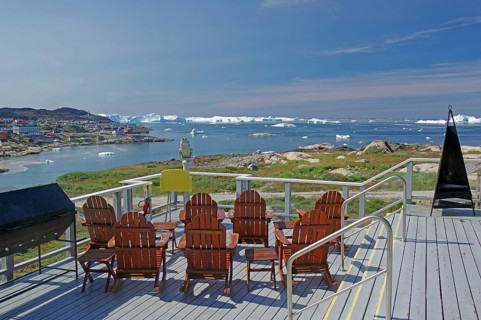 Terrace with chairs and view of the sea with icebergs, clear view and blue sky, Tourismu, Hotel,