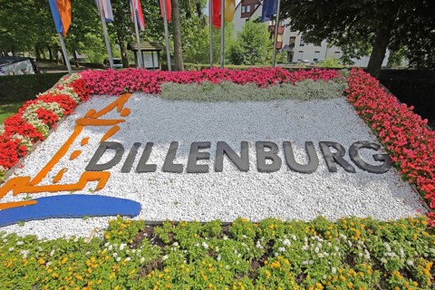 Colourful flower bed with flags, floral decoration and inscription, Dillenburg, Hesse, Germany,