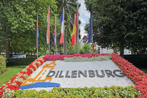 Colourful flower bed with flags, floral decoration and inscription, Dillenburg, Hesse, Germany,