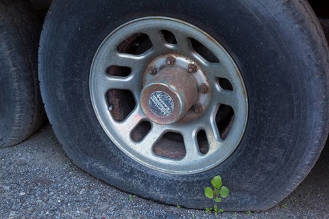 Close-up of flat tire on old abandoned motor vehicle, Quebec, Canada, North America