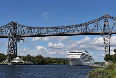 Cruise ship Europa 2 passes through the railway bridge in the Kiel Canal in Rendsburg, Kiel Canal,