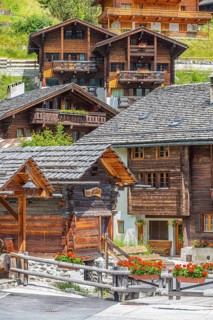 Old wooden houses with wooden shingle roofs in the historic centre of Grimentz, Val d'Anniviers,