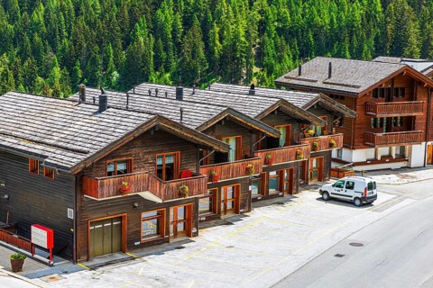 Parked car in front of wooden terraced houses, historic village centre, Grimentz, Val d'Anniviers,