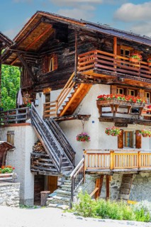 Wooden outside steps on an old house, flower boxes in front of windows and balconies, historic