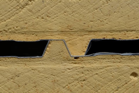 Background of plastic foam cladding on a building site. sandwiched between layers of colour steel,