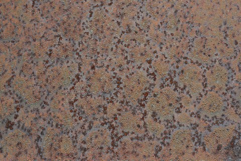 Grunge background of blistered paint on rusty metal