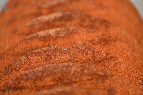 Grunge background of rusted plough shares on an old cultivator