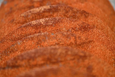 Grunge background of rusted plough shares on an old cultivator