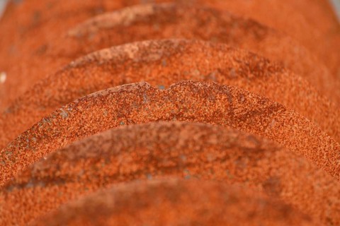 Grunge background of rusted plough shares on an old cultivator