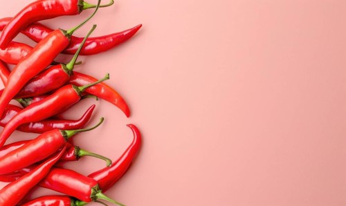 Top view of colorful peppers on a pink background AI generated