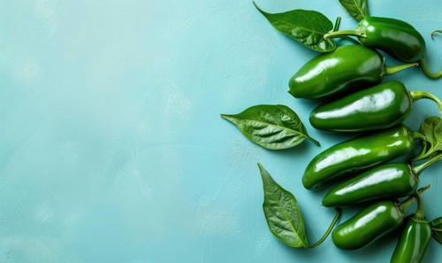 Top view of hot peppers scattered on a pastel blue background AI generated