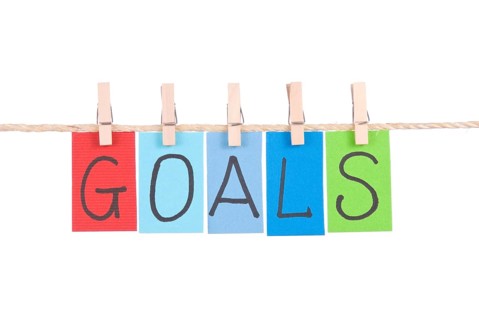 Goals, Colorful words hang on rope by wooden peg