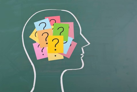 Human brain and colorful question mark draw on blackboard