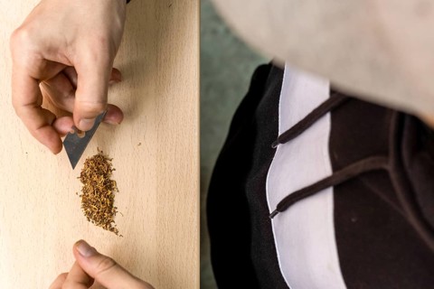 Hands preparing marijuana on the table