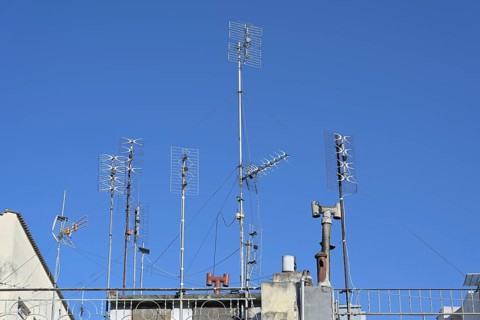 Various antennas on the roof of a residential apartment building, installation for communication