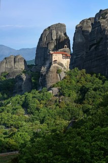 Monastery of St. Nicholas Anapausas situated at the top of a cliff in the rocky Meteora landscape
